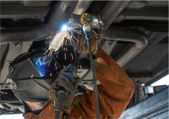Custom exhaust fabrication and welding in JBA Speed Shop garage