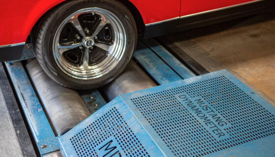 A close up shot of a back wheel on a chassis dyno